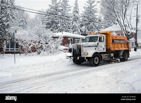 A yellow City of Ottawa snow plow truck roams the Glebe streets during ...