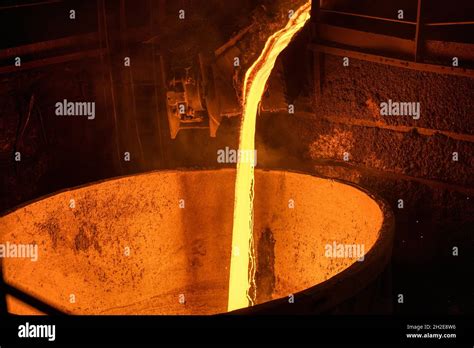 A stream of molten slag is poured into a metallurgical ladle Stock Photo - Alamy