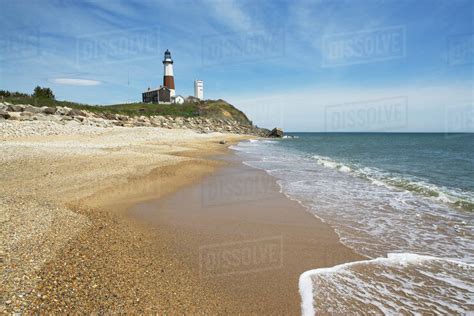 Beach with lighthouse in background - Stock Photo - Dissolve