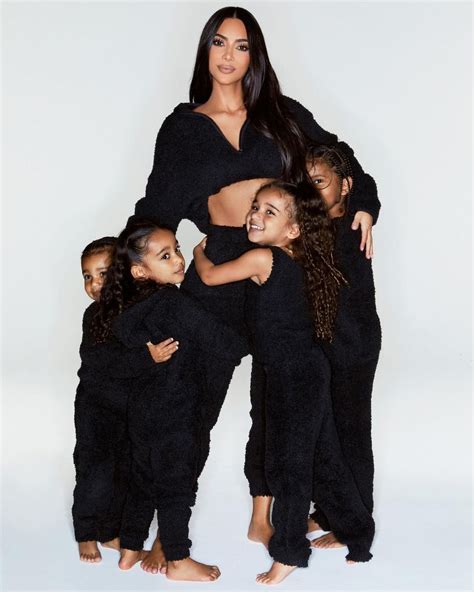 Kim Kardashian shows off her abs as she poses with four kids after ...