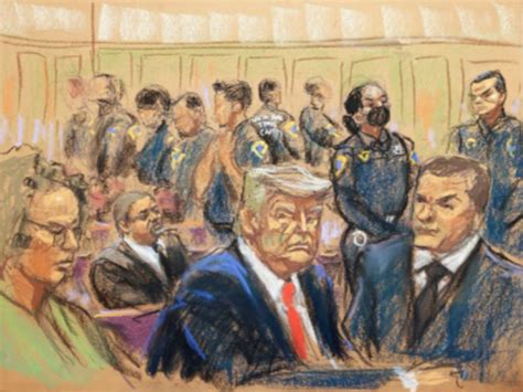 Glum Trump flanked by police officers in official arraignment photo