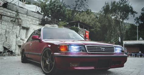 Red Toyota Sedan With Headlights on · Free Stock Photo