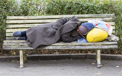 Homeless man sleeping on a bench - labm