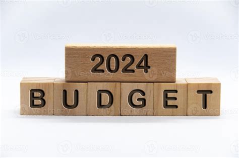 Budget 2024 text engraved on wooden blocks with white cover background. Budgeting business ...