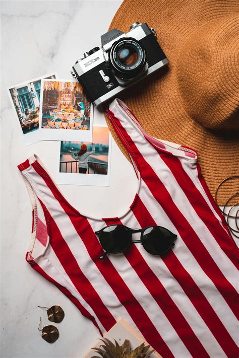 Black and White Dslr Camera on White and Red Striped Tote Bag · Free Stock Photo