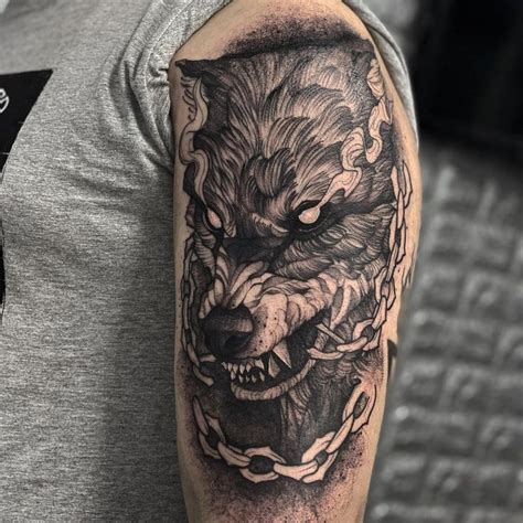 a man with a tattoo on his arm has a wolf in chains around his neck