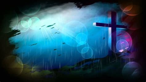 a cross in the middle of a blue and green background with rain drops on it