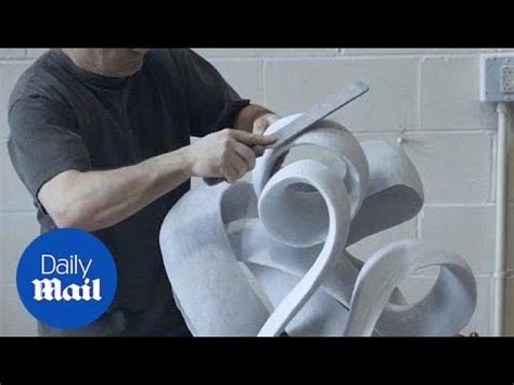 Artist sculpts a block of marble