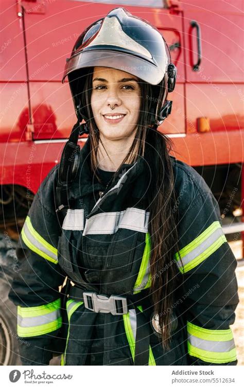 Woman firefighter in protective uniform and helmet - a Royalty Free Stock Photo from Photocase