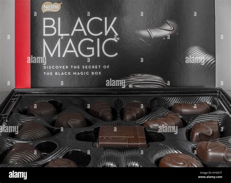 Nestlé Black Magic open box of dark chocolates. Closeup of the different shaped chocolate ...