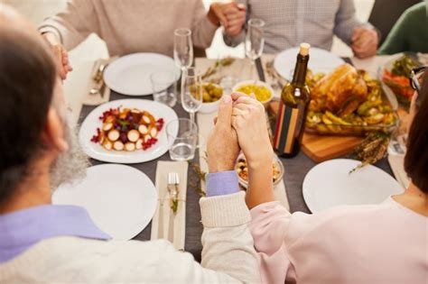 Premium Photo | Family praying during dinner