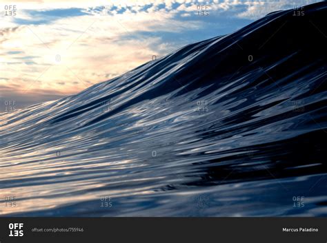 Large ocean wave starting to crest stock photo - OFFSET