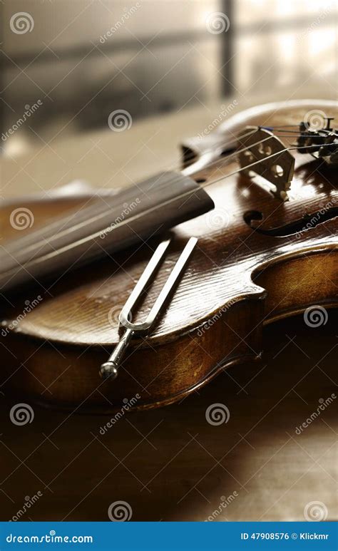 Violin and tuning fork stock photo. Image of note, play - 47908576