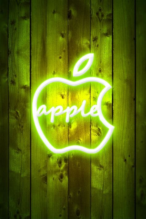 an apple neon sign sitting on top of a wooden wall