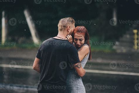 beautiful couple hugging in the rain 11781584 Stock Photo at Vecteezy