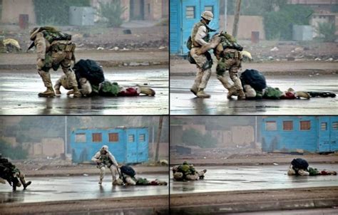 A group of Ukrainian soldiers covers a soldier who is trying to drag away a seriously wounded ...