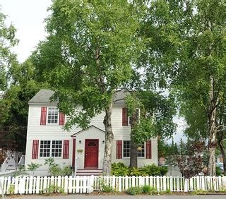 Red and White saltbox style house, white picket fence, bir… | Flickr