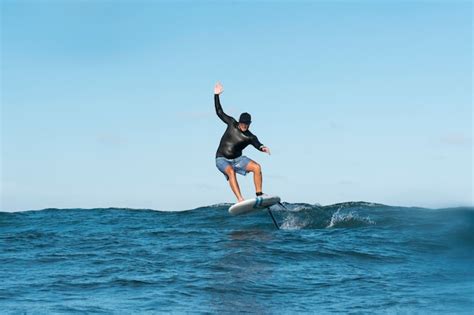 Free Photo | Sporty man surfing in hawaii