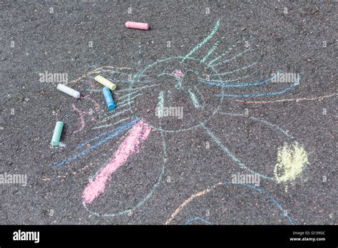 Kids chalk art on black pavement Stock Photo - Alamy