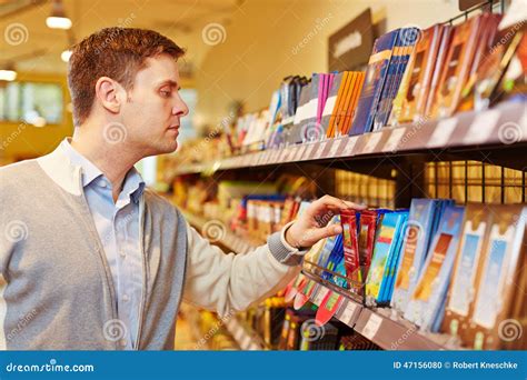 Man Buying Chocolate In Supermarket Stock Photo - Image of organic ...