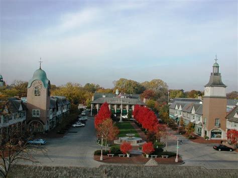 an aerial view of a town with red trees