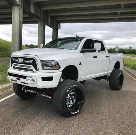 a white ram truck parked under an overpass