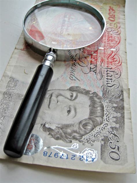 Magnify glass and 50 pound note | Analyse your finances and … | Flickr