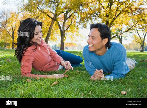 Couple laying in grass Stock Photo - Alamy