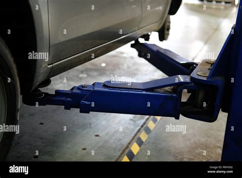 car on lift in automobile service repair garage Stock Photo - Alamy