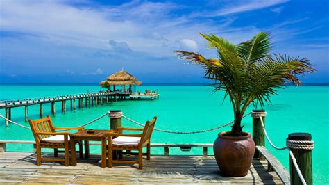 Download Horizon Tropical Turquoise Sea Ocean Chair Hut Pier Man Made Resort HD Wallpaper