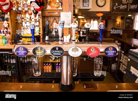 Beer taps showing the names of beer brands in a typical British pub ...