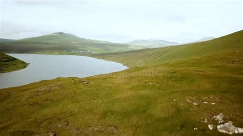 View of Sorvagsvatn Lake Above the Ocean and Legs Man Sitting Edge ...