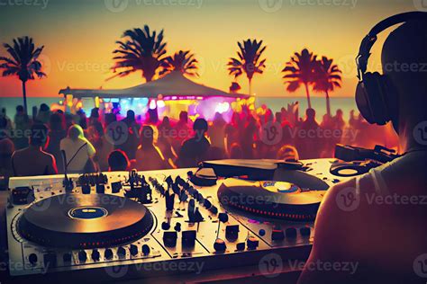 Dj mixing outdoor at beach party festival with crowd of people in ...