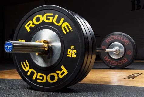 A Rogue Olympic weightlifting barbell - loaded with Rogue training ...