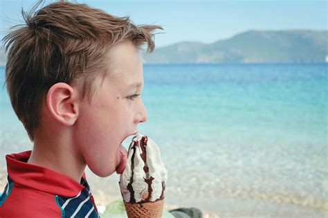 Boy eating ice cream Photograph by Tom Gowanlock