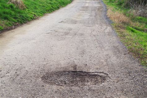 Old Broken Road at the Edge of a Village in Spring Season. Poor Road Conditions. Stock Image ...