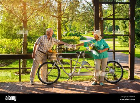 Senior people near tandem bike Stock Photo - Alamy