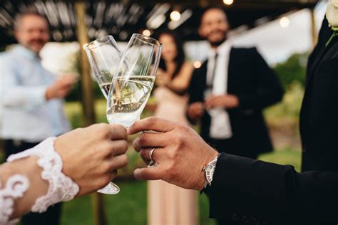 Bride and groom with glasses of champagne - Unpacked