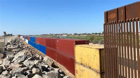 Gaps in Arizona border wall filled with double-stacked shipping containers