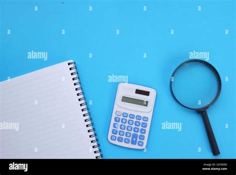 Flat Lay A Calculator And A Magnifying Glass White Notebook On The Blue Desk In The Office Stock ...
