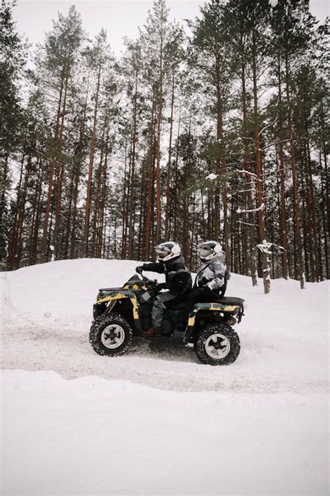 Man Riding and ATV in the Snow · Free Stock Photo