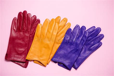 Red, Yellow and Blue Gloves on a Pink Background Stock Photo - Image of female, accessory: 264900756