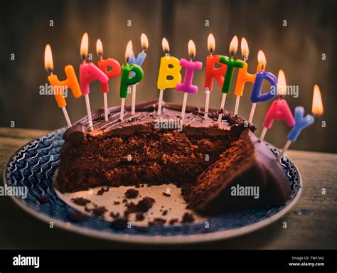 Happy birthday chocolate cake with colourful lit candles Stock Photo ...