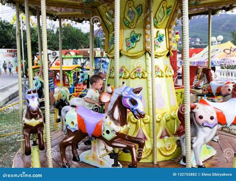 Young Children Ride on the Carousel Horse Editorial Photography - Image ...