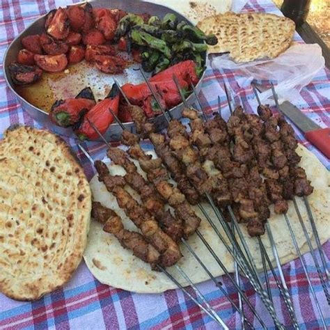 there are many different types of food on this picnic table, including ...