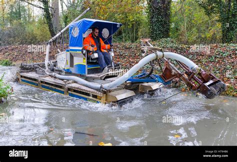 Silt removal and dredging machine from Aquatic Solutions UK in a stream Stock Photo - Alamy