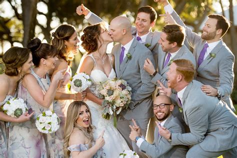 The newly weds kiss while their bridal party celebrate during the Longboat Key Harborside ...