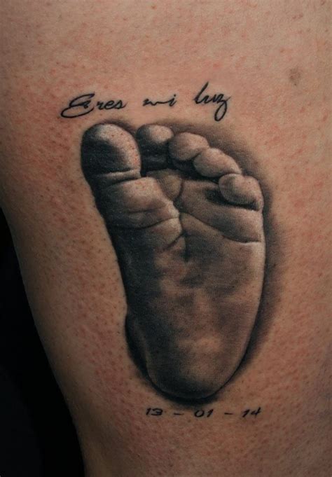 Tattoo of a baby's foot and birth date. | Baby feet tattoos, Baby tattoos, Tatoo designs