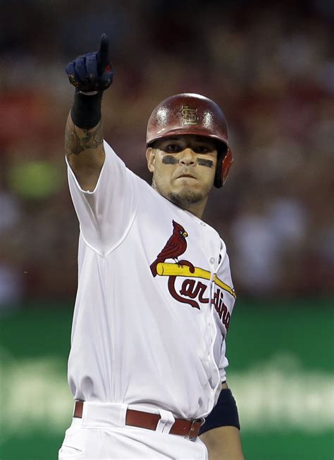 St. Louis Cardinals' Yadier Molina points after hitting a double during ...