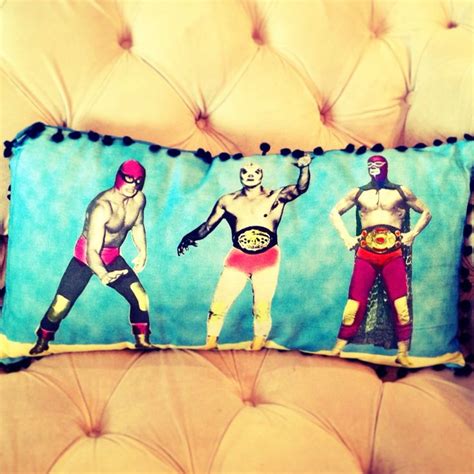 a pillow with three wrestlers on it